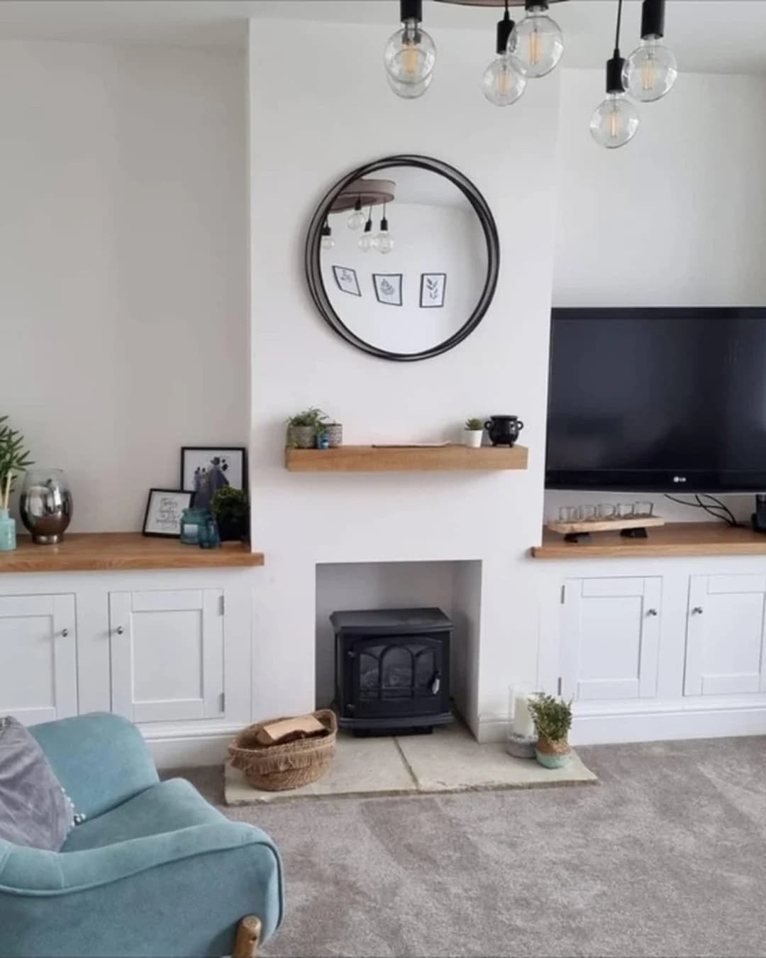 Bespoke alcove cabinetry with oak tops, built around a fireplace in a Swindon living room